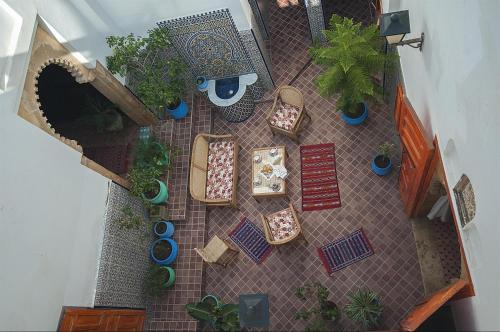 an overhead view of a patio with furniture and plants at Riad Dar Jabador in Sale