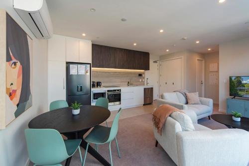 a living room with a couch and a table at Malthouse Lane City Apartment 3 in Nelson