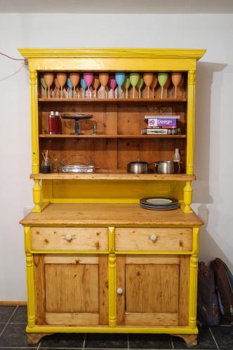 a wooden cabinet with bowls and dishes on it at Apartament Art Cluj in Cluj-Napoca