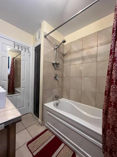 a bathroom with a white tub and a shower at Le Chal'heureux, ski & spa, ski-in ski-out in Val-Brillant