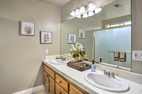 a bathroom with two sinks and a large mirror at Charming Redding Home with Furnished Patio! in Redding