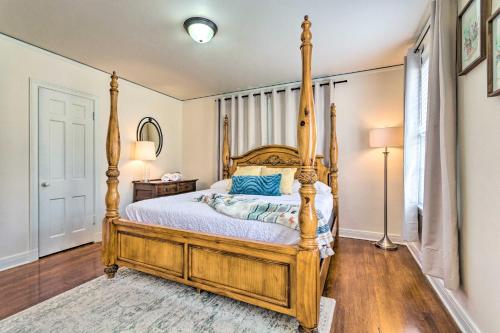 a bedroom with a wooden bed with a wooden frame at Little Rock Home about 5 Mi to Downtown! in Little Rock