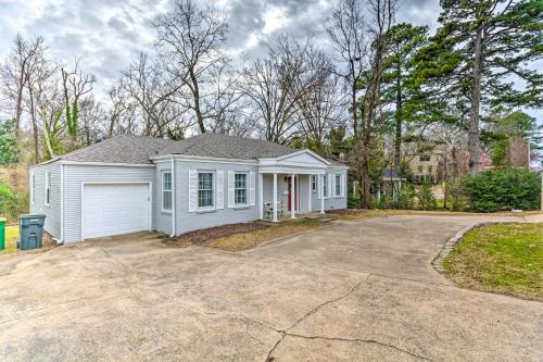 a white house with a garage in a driveway at Little Rock Home about 5 Mi to Downtown! in Little Rock