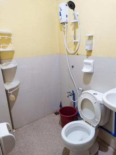 a bathroom with a toilet and a shower at Joyful Guest House in El Nido