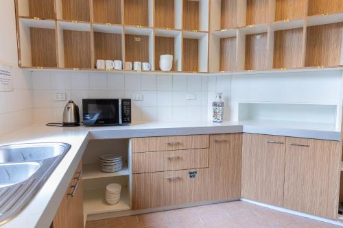 a kitchen with a sink and a microwave at 50 Green St Windsor in Melbourne