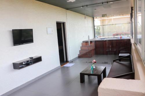 a living room with a couch and a table at Sia Signature Calangute in Calangute