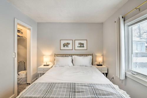 a white bedroom with a bed with two night stands at Anchorage Home, Minutes From Downtown! in Anchorage