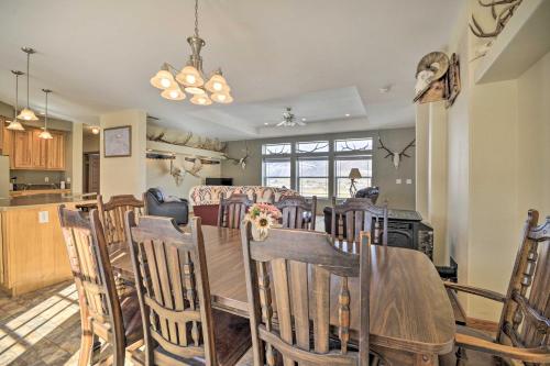 a dining room and kitchen with a table and chairs at Charming Cody Vacation Home with Mtn Views! in Cody