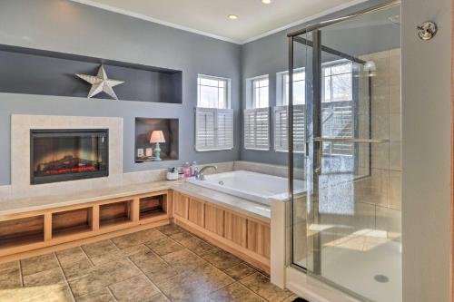 a bathroom with a tub and a fireplace at Charming Cody Vacation Home with Mtn Views! in Cody