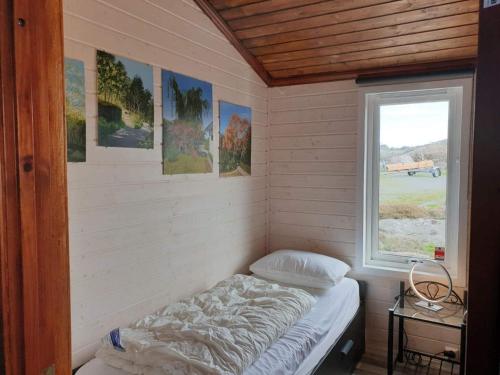 a small room with a bed and a window at Holiday home skudeneshavn III in Skudeneshavn