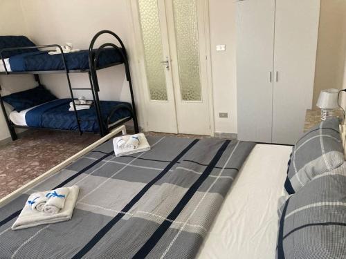 a bedroom with two bunk beds with towels on the bed at La scaletta sul mare di Pizzo [ WiFi e Disney+ ] in Pizzo