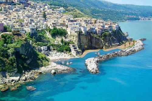 an aerial view of a beach with boats in the water at La scaletta sul mare di Pizzo [ WiFi e Disney+ ] in Pizzo