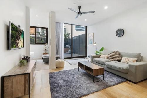 a living room with a couch and a table at Stylish One BD Hideaway in Essendon in Melbourne
