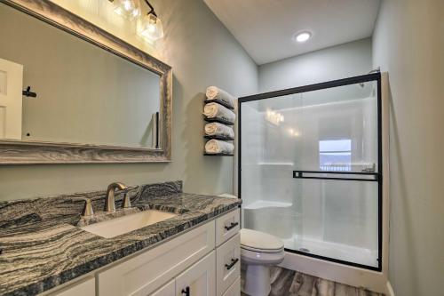 a bathroom with a sink and a shower and a mirror at Refreshing Tennessee Vacation Rental! in La Follette