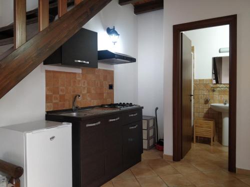 a kitchen with a sink and a stove top oven at Agriturismo Fratelli Mizzon in Sabaudia