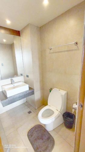 a bathroom with a white toilet and a sink at Splendido Tagaytay Taal Lake Staycation Free Parking Netflix No Free Pool in Tagaytay