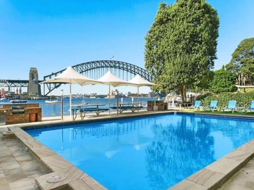 a large swimming pool with a view of the sydney harbour at Harbourside7 - modern 1br unit with fab views in Sydney