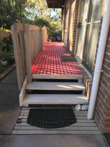 a porch with a set of stairs leading into a house at Canaan Homestay in Watsonia North