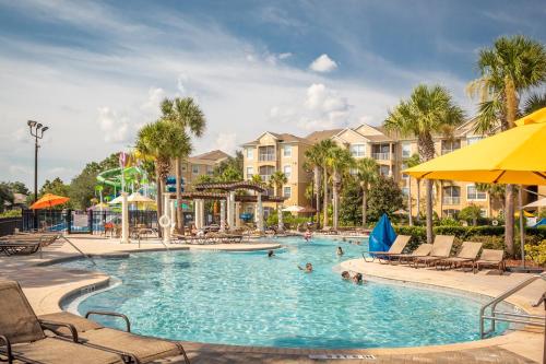 a pool at a resort with people in it at The Wish House, just miles from Disney World in Orlando