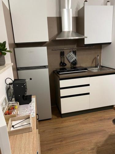 a kitchen with a stove and a refrigerator at M&G holiday house in Matera