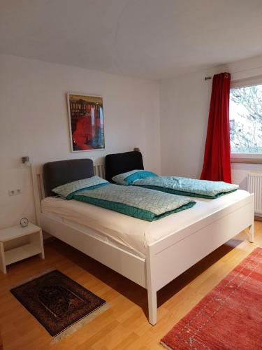 a white bed in a room with a window at Nagoldtal - große Fewo mit Terrasse in Nagold