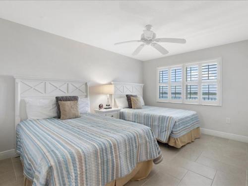 1 dormitorio con 2 camas y ventilador de techo en Estero Island Beach Villas 601, 2 Bedrooms, Beach Front, WiFi, Sleeps 6, en Fort Myers Beach
