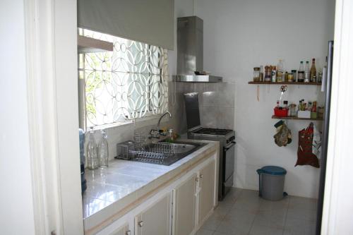 a kitchen with a sink and a stove at 21LG Ilot Fortier M Sea Front and Swimming pool in Rivière Noire