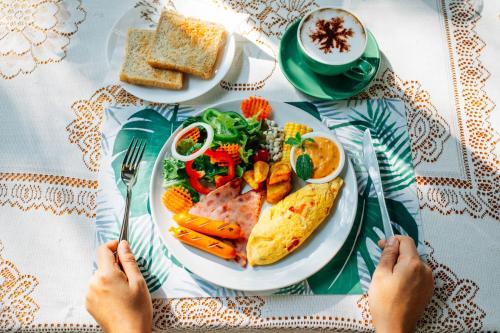a plate of food on a table with a plate of food at Treescape Resort Chiangmai in Chiang Mai