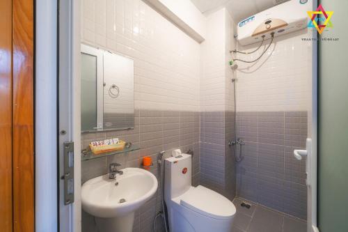 a small bathroom with a sink and a toilet at Villa Tuan Vu Da Lat in Da Lat