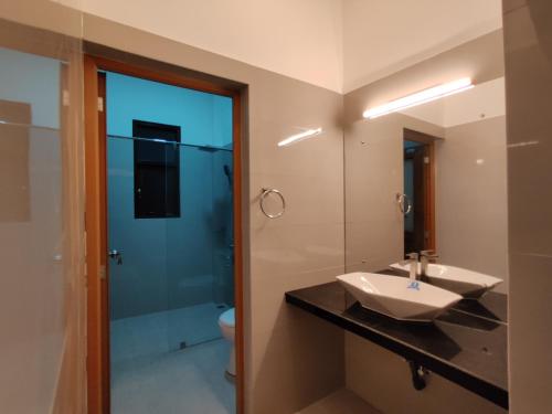 a bathroom with a sink and a shower at Highway Twin Home East wing in Kadawatha