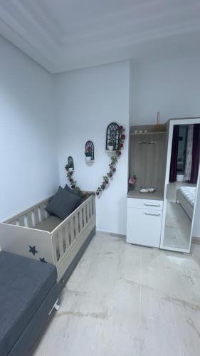 a living room with a bed and a mirror at The jewel of the coast in Sousse
