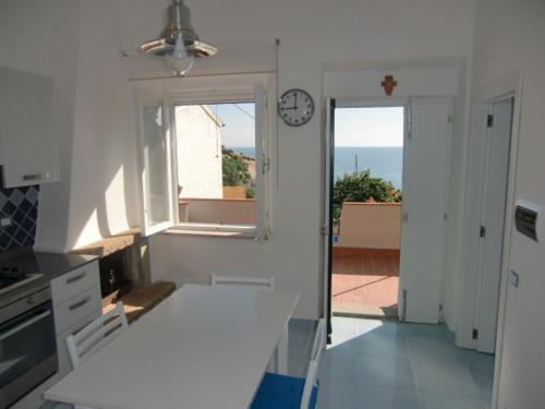 a kitchen with a window and a clock on the wall at Ammiraglio in Campese
