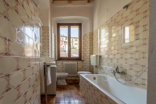 een badkamer met een bad, een toilet en een wastafel bij Casa al Borgo Como lake in Ossuccio