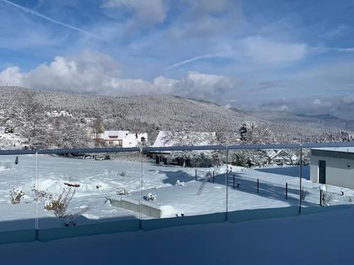 a view of a snow covered mountain from a building at Gîte "Villa Belle Vie" in Labaroche