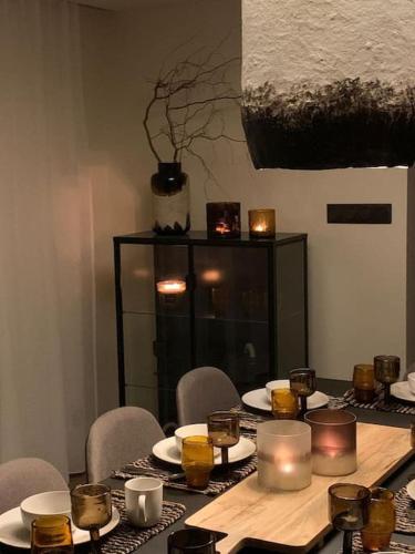 a table with candles and plates and cups on it at Gîte "Villa Belle Vie" in Labaroche