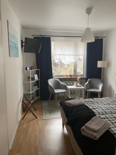 a bedroom with a bed and a table and chairs at A&M in Nynäshamn