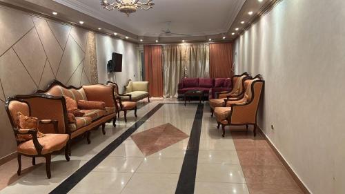 a waiting room with leather chairs and a waiting room at 84 جسر السويس الدور 6 in Cairo