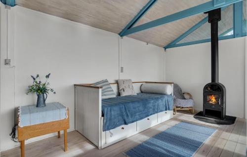 a bedroom with a bed and a wood stove at Lovely Home In Kalundborg With Kitchen in Kalundborg