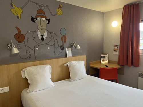 a bedroom with a bed with a painting on the wall at initial by balladins Tours Sud in Chambray-lès-Tours