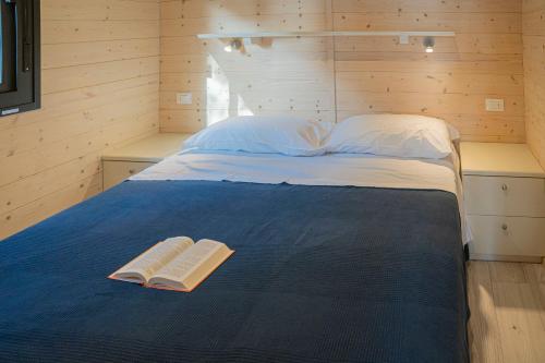 a bedroom with a bed with two books on it at Villaggio Smeraldo in Moneglia