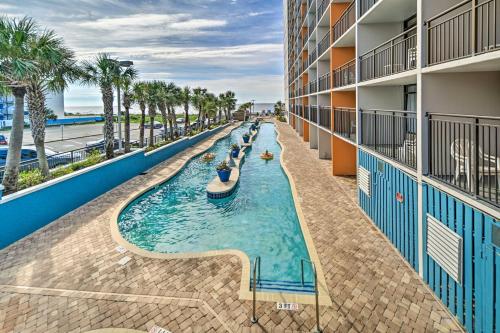 an indoor pool at a resort with palm trees at Oceanfront Balcony Resort Condo in Myrtle Beach in Myrtle Beach