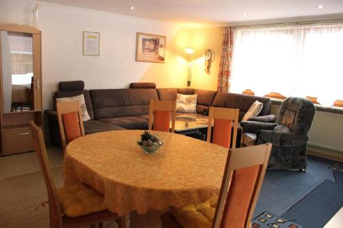 a living room with a table and a couch at Ferienwohnung Christa in Mauth