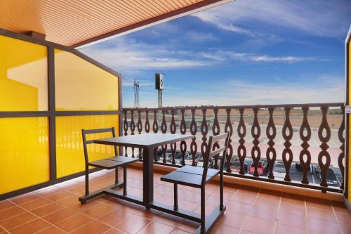 a balcony with a table and chairs and a view of the ocean at Hotel Moya in Honrubia
