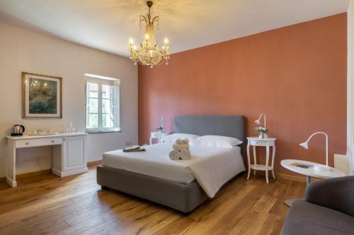 a bedroom with a bed with a teddy bear on it at B&B Ninfeo dell' Arancera in Calci