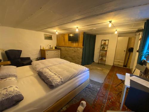 a bedroom with a large bed and a kitchen at Art Boutique Budget Apartment im Hinterhof Menden Altstadt in Menden