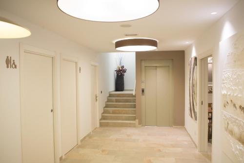 a hallway with stairs and a large light fixture at Osabarena Hotela in Orozko