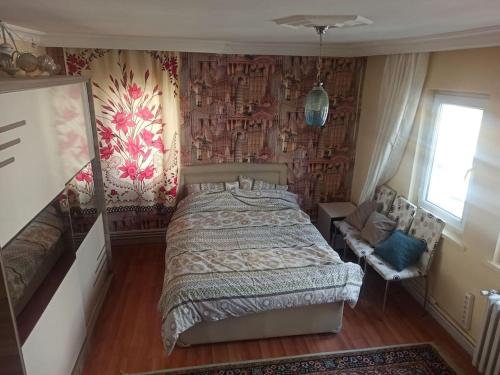 a bedroom with a bed in a room with wallpaper at This house is Not active in Altındağ