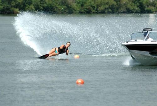 a person water skiing on a boat in the water at Petit coin de paradis, vue panoramique mer &montagne, piscine privée... in Calcatoggio