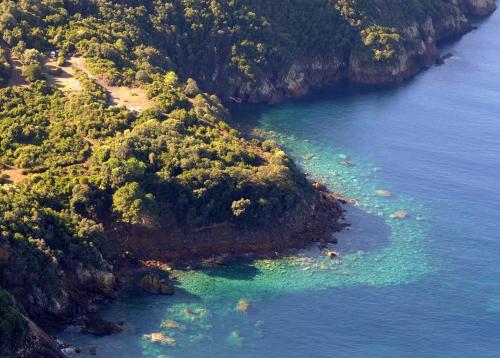 an aerial view of an island in the ocean at Petit coin de paradis, vue panoramique mer &montagne, piscine privée... in Calcatoggio