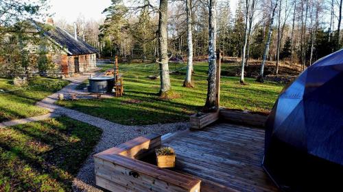 an aerial view of a backyard with a wooden deck at Ozoli - Pirts / Viesunams in Alande